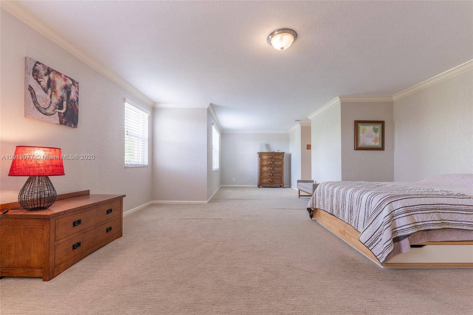 12358 St Simon Drive Boca Raton, FL 33428 - Photo 47 of 89 a spacious bedroom with a bed and a flat screen tv