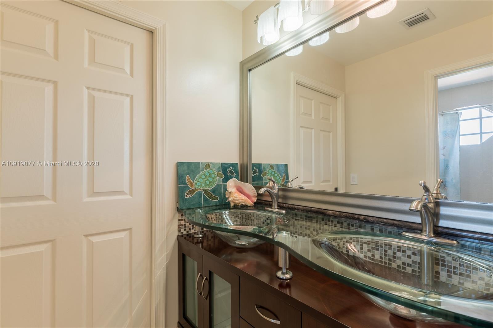 12358 St Simon Drive Boca Raton, FL 33428 - Photo 52 of 89 a kitchen with a sink and cabinets
