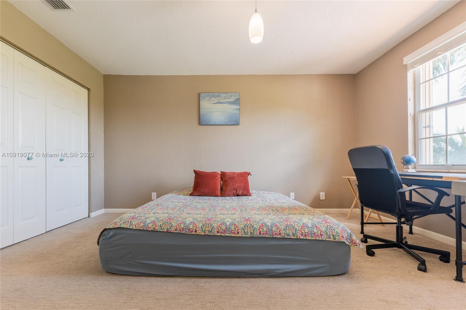 12358 St Simon Drive Boca Raton, FL 33428 - Photo 55 of 89 a bedroom with a bed chair and a window