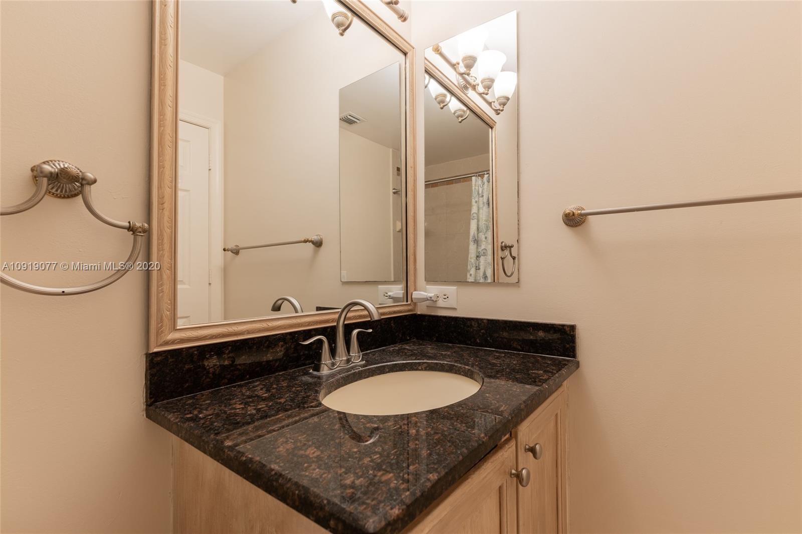 12358 St Simon Drive Boca Raton, FL 33428 - Photo 58 of 89 a bathroom with a granite countertop sink and a mirror