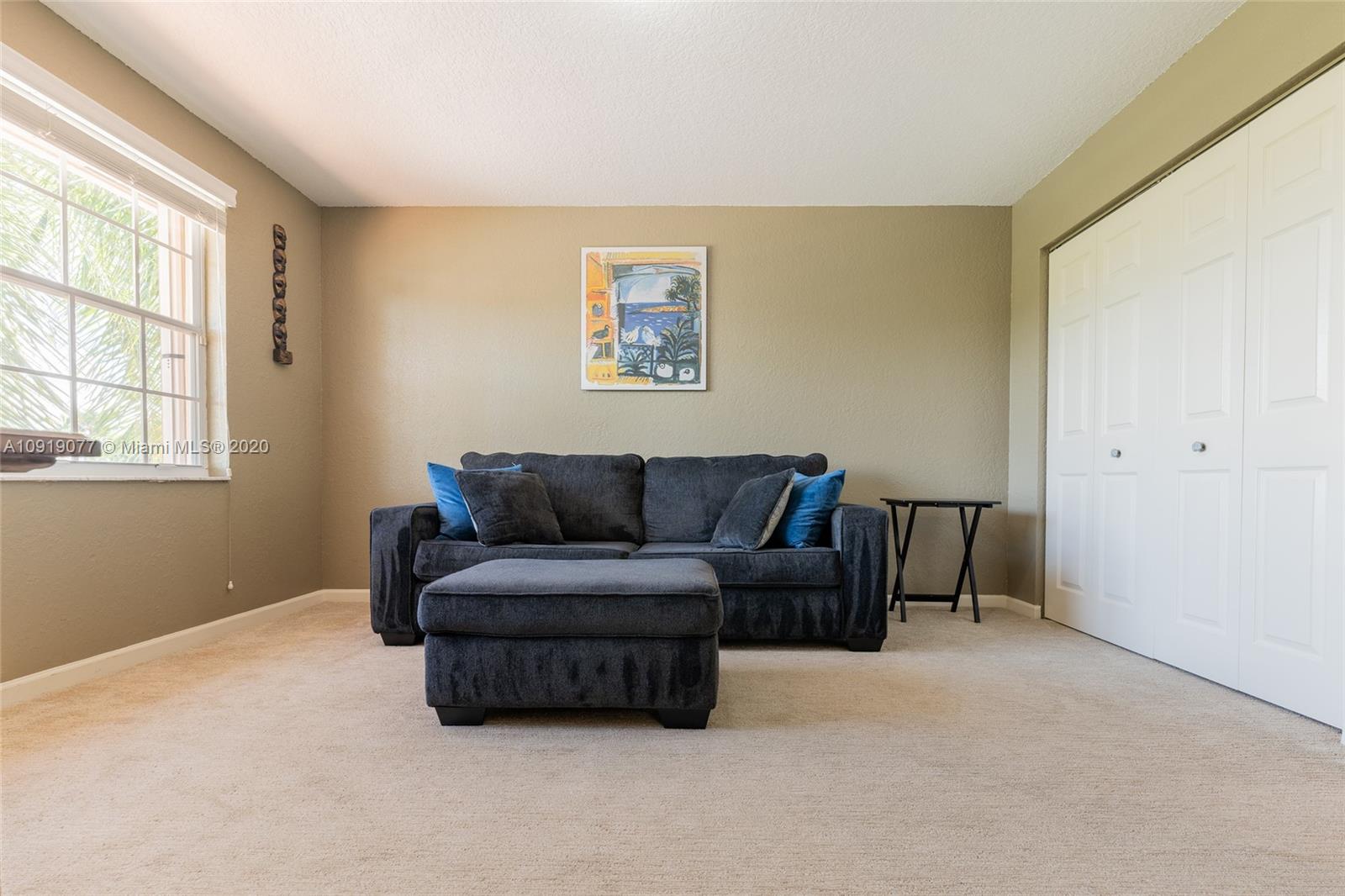 12358 St Simon Drive Boca Raton, FL 33428 - Photo 59 of 89 a living room with furniture and a window