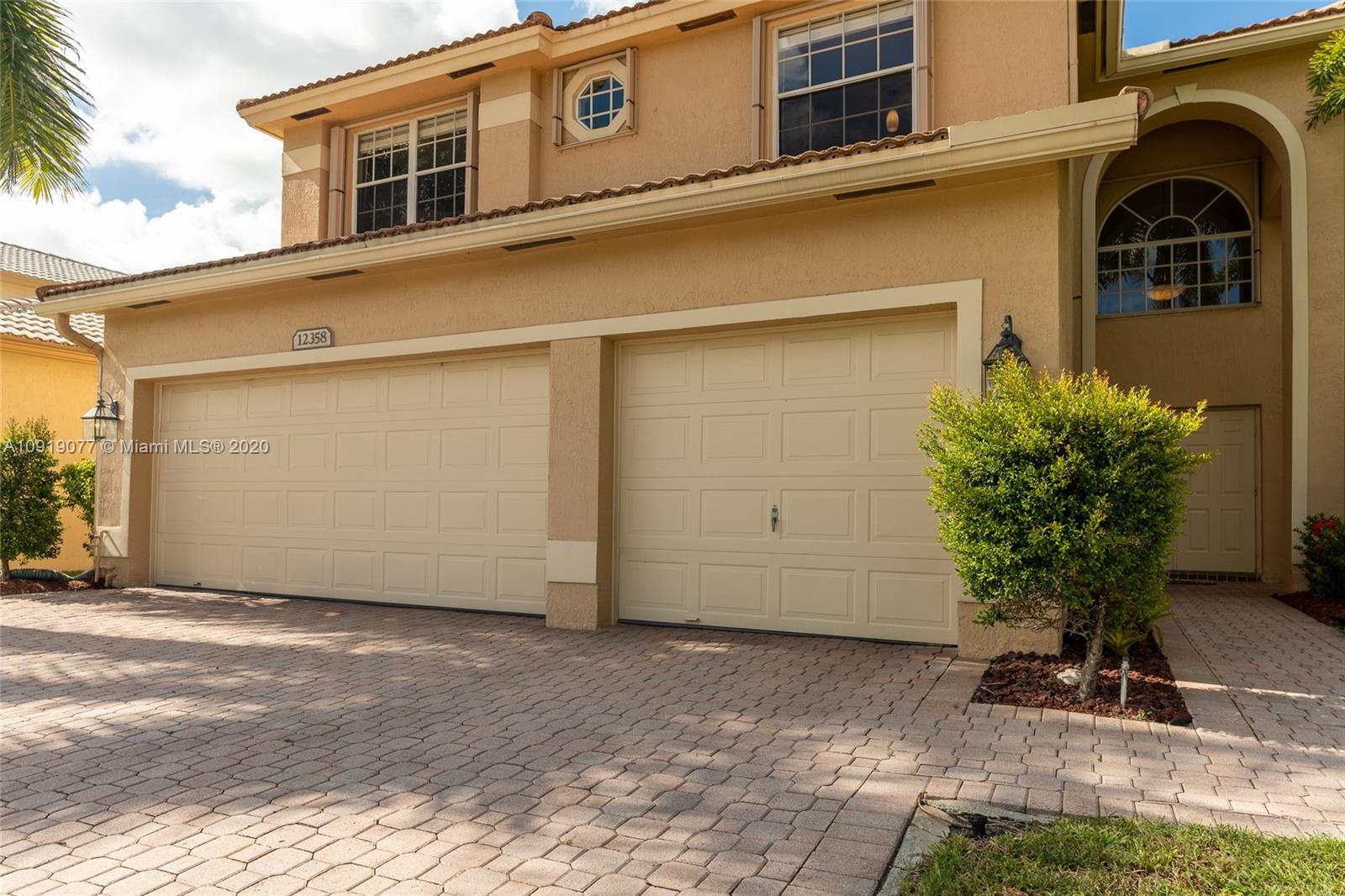 12358 St Simon Drive Boca Raton, FL 33428 - Photo 6 of 89 a front view of a house with garden