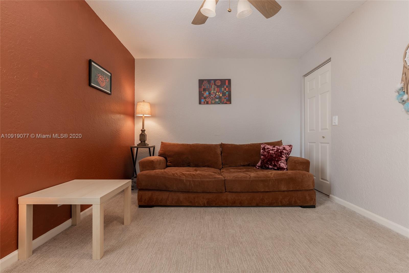 12358 St Simon Drive Boca Raton, FL 33428 - Photo 64 of 89 a living room with a couch and a potted plant