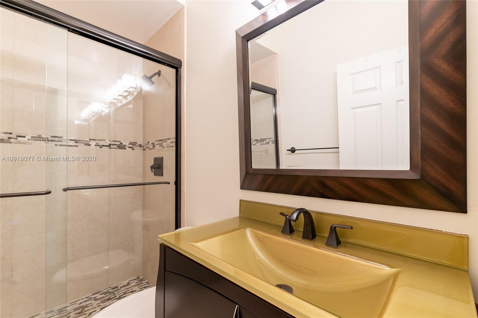 12358 St Simon Drive Boca Raton, FL 33428 - Photo 66 of 89 a bathroom with a sink and a mirror