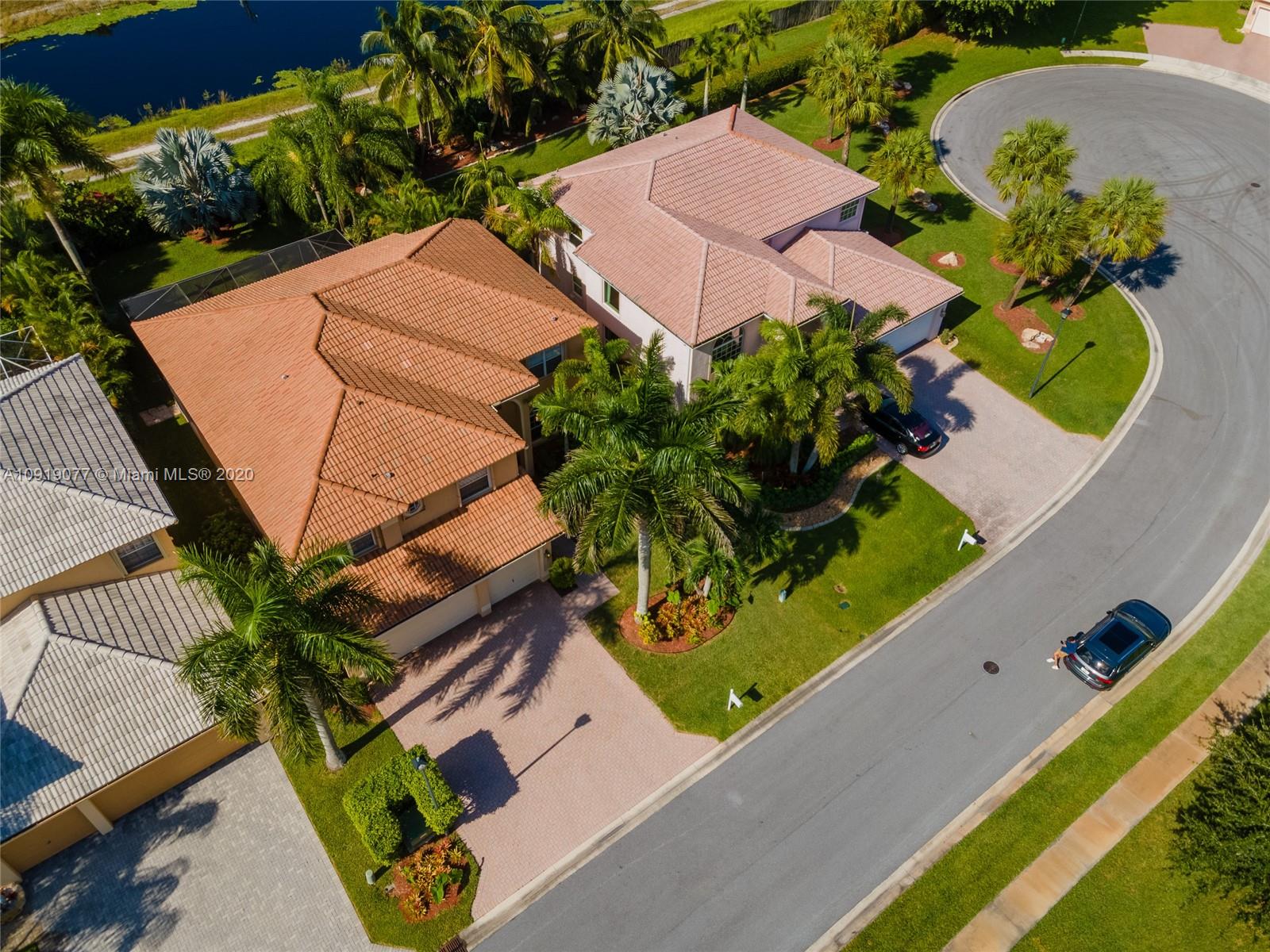 12358 St Simon Drive Boca Raton, FL 33428 - Photo 78 of 89 an aerial view of a house with a yard and potted plants