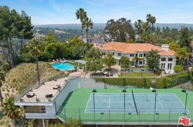 an aerial view of a house with a yard basket ball court and outdoor seating
