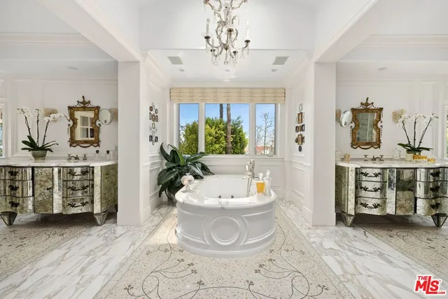 a spacious bathroom with a double vanity sink a mirror and a bathtub