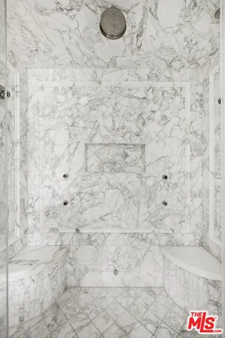 a granite bathroom with a shower