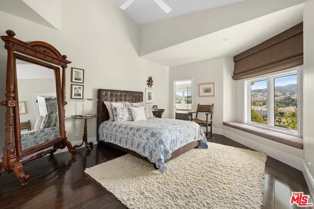 a bedroom with a large bed and a window