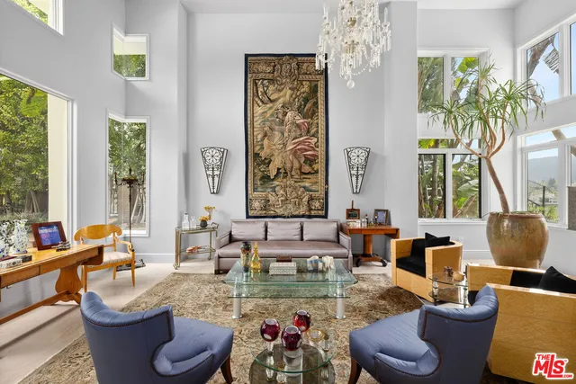 a living room with fireplace furniture and a large window