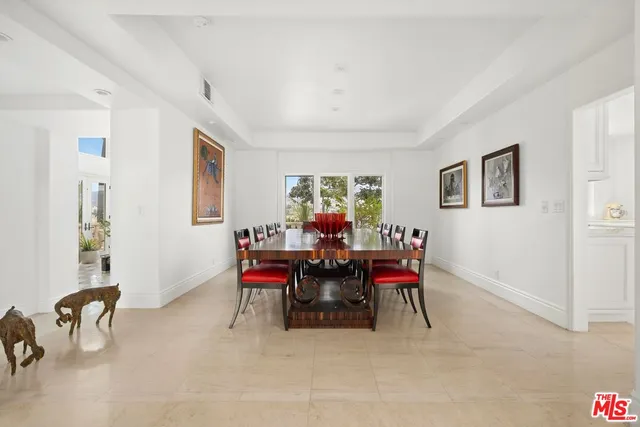 a view of a dining room with furniture and a window
