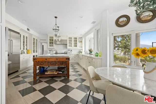 a living room with a table and chairs