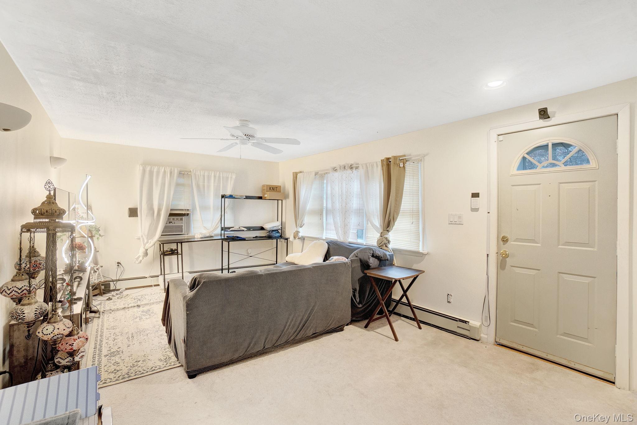 8 Evergreen Road Rocky Point, NY 11778 - Photo 11 of 20 a living room with furniture and a table