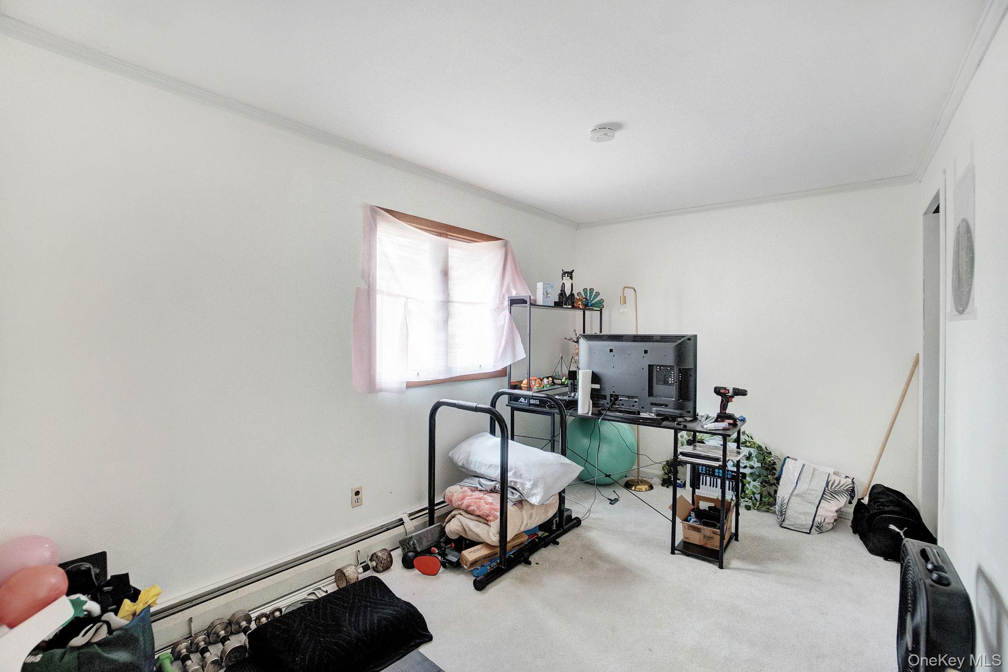 8 Evergreen Road Rocky Point, NY 11778 - Photo 13 of 20 a room with gym equipment and a window