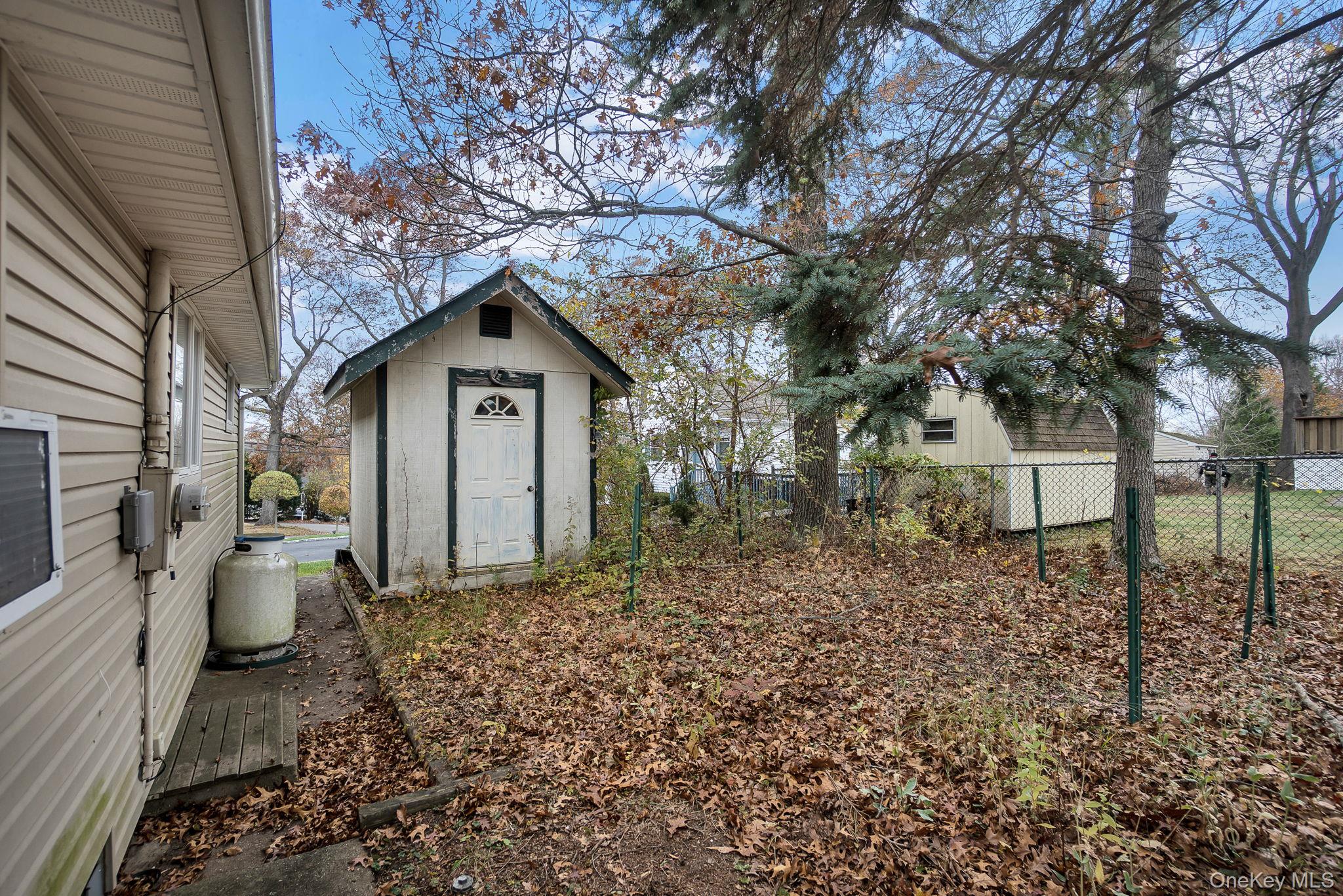 8 Evergreen Road Rocky Point, NY 11778 - Photo 17 of 20 a front view of a house with garden