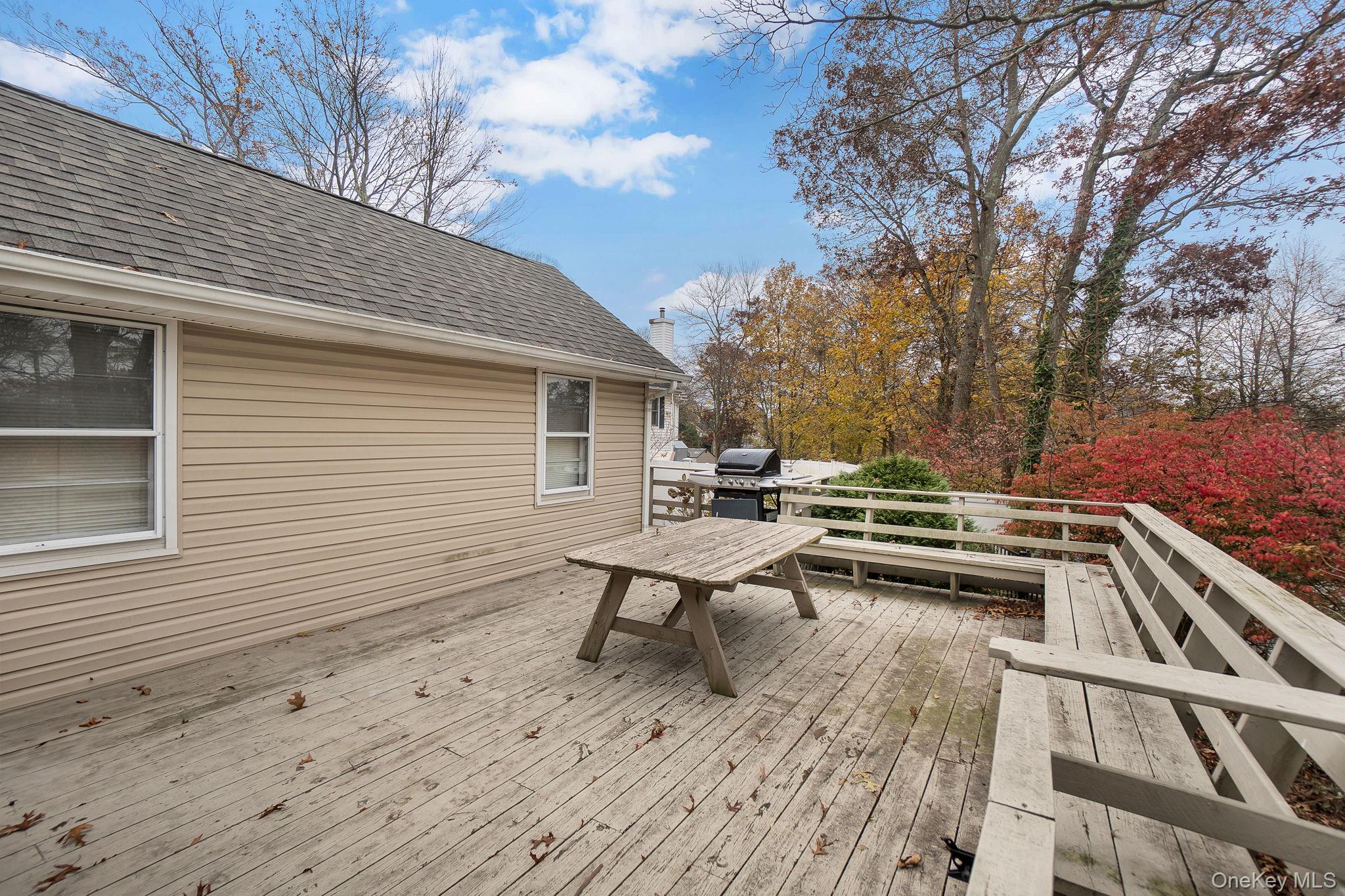 8 Evergreen Road Rocky Point, NY 11778 - Photo 18 of 20 a view of a roof deck with wooden floor and fence