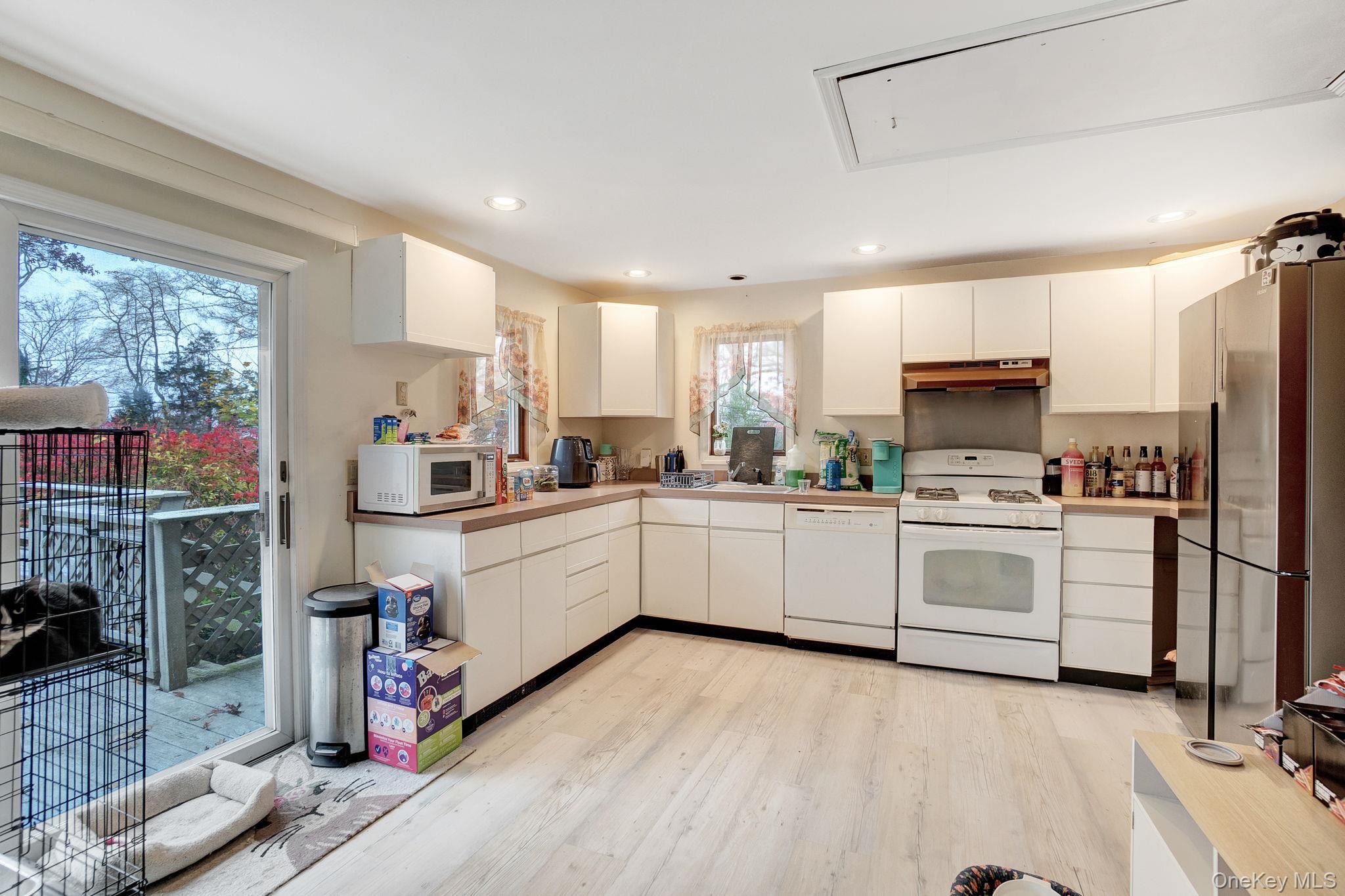 8 Evergreen Road Rocky Point, NY 11778 - Photo 4 of 20 a kitchen with sink cabinets stainless steel appliances and window
