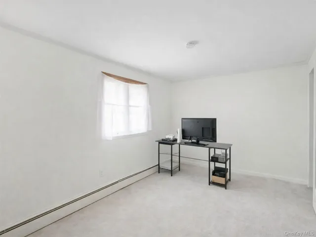 an empty room with furniture and window