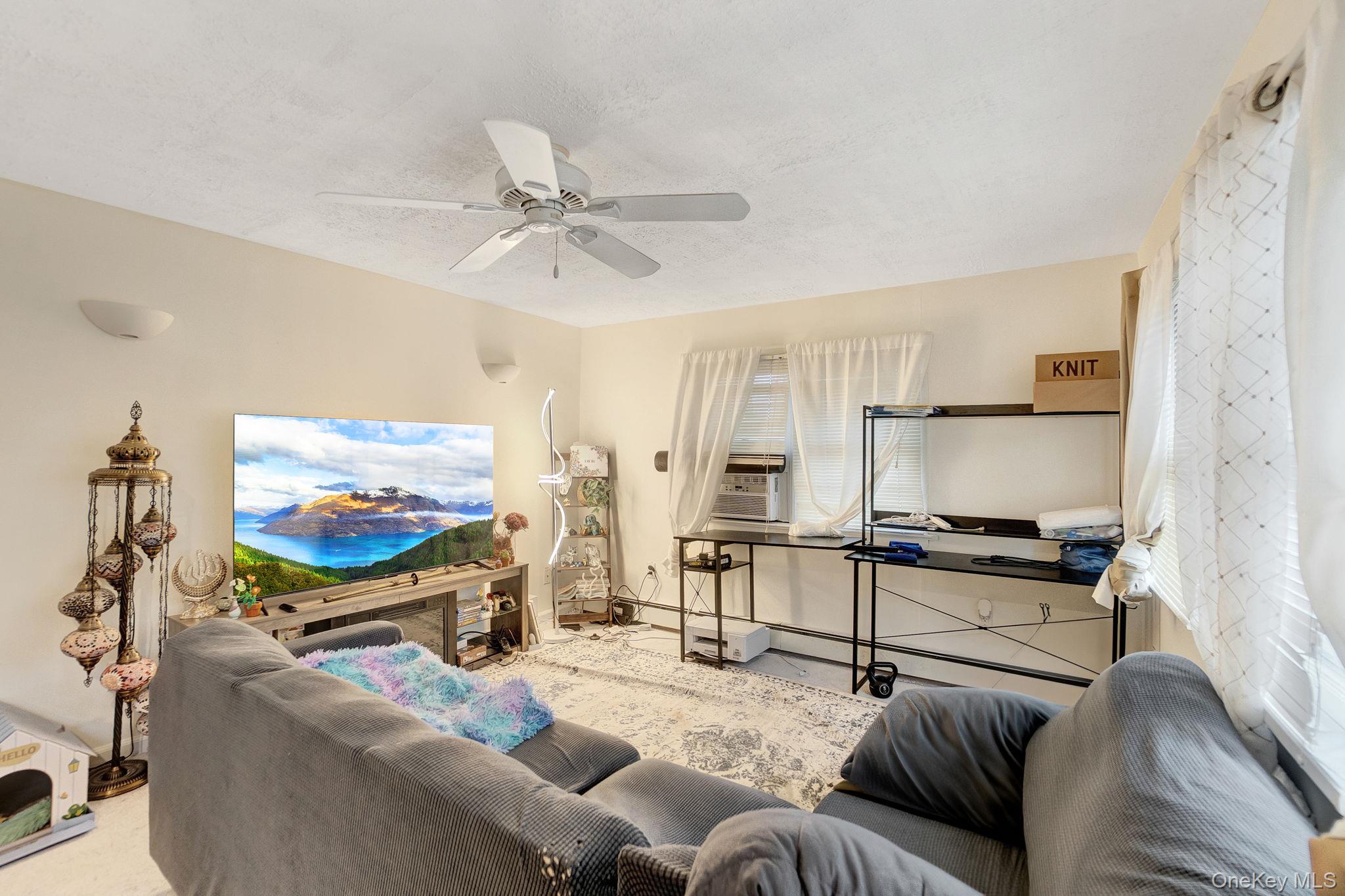 8 Evergreen Road Rocky Point, NY 11778 - Photo 8 of 20 a living room with furniture and a flat screen tv