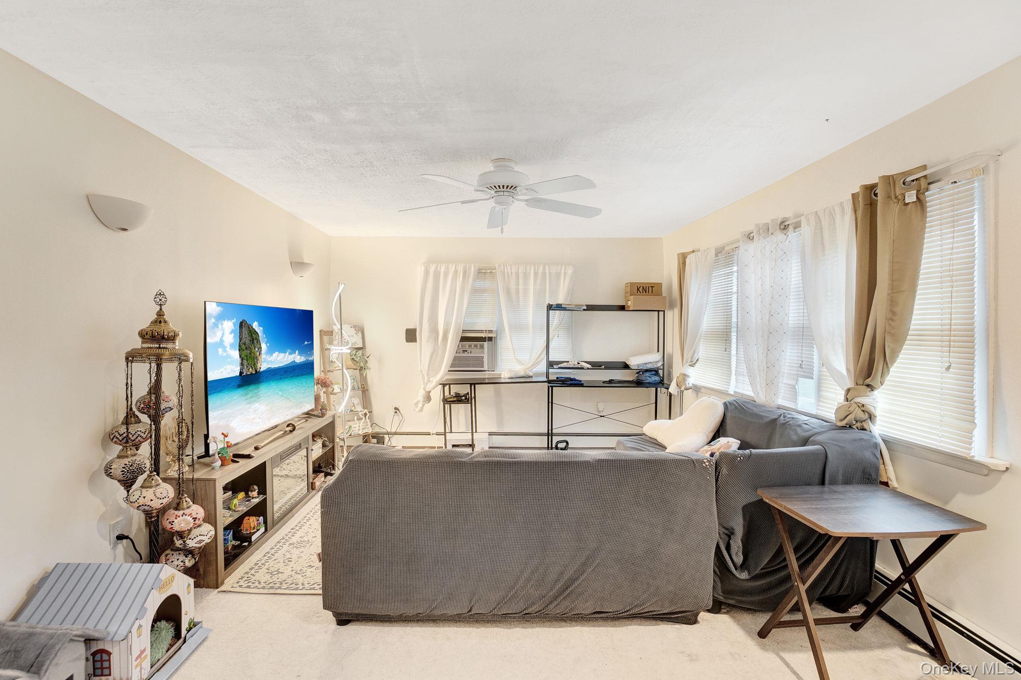 8 Evergreen Road Rocky Point, NY 11778 - Photo 9 of 20 a living room with furniture and a flat screen tv