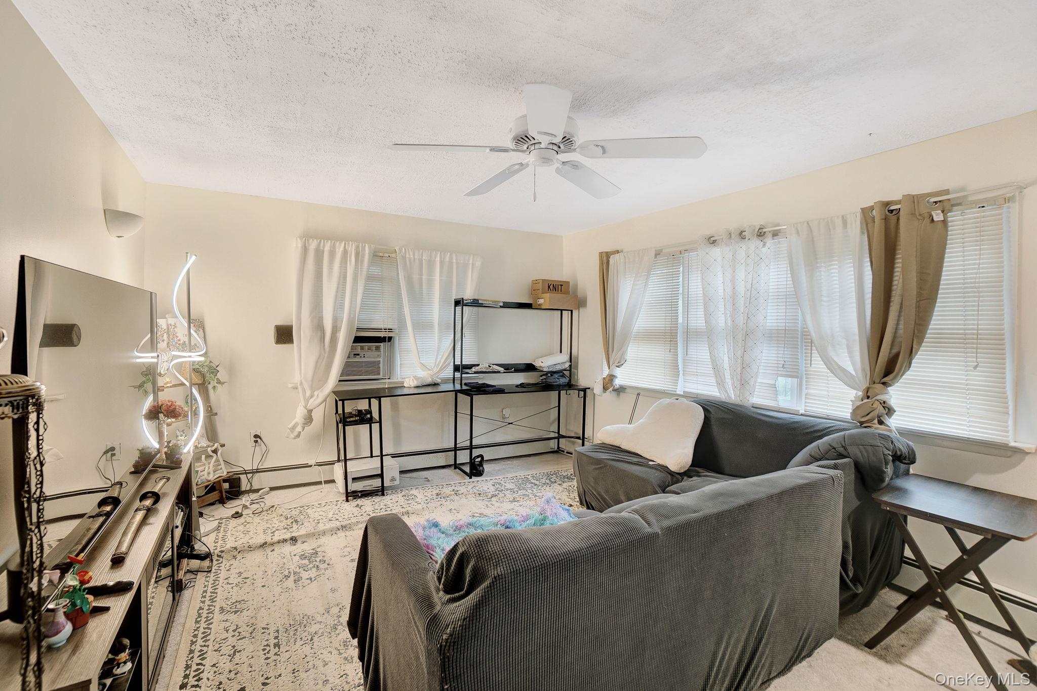 8 Evergreen Road Rocky Point, NY 11778 - Photo 10 of 20 a living room with furniture and a flat screen tv