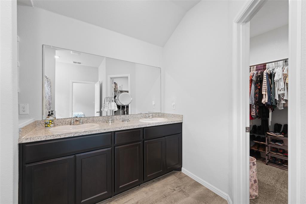 9020 Ridgeriver Way Fort Worth, TX 76131 - Photo 16 of 26 a bathroom with a double vanity sink and a mirror