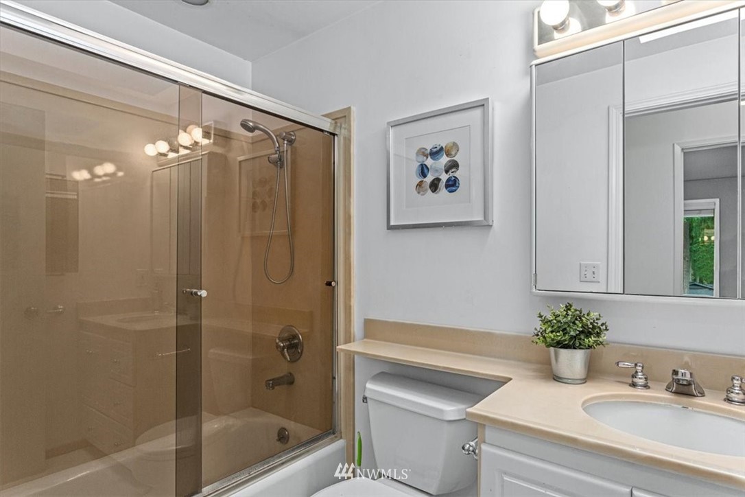 21918 7th Place West Bothell, WA 98021 - Photo 11 of 25 a bathroom with a granite countertop sink a toilet and shower