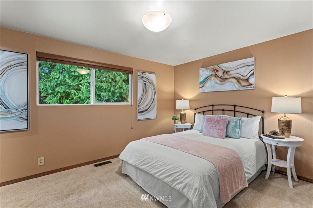 21918 7th Place West Bothell, WA 98021 - Photo 14 of 25 a bedroom with a bed and a painting on the wall