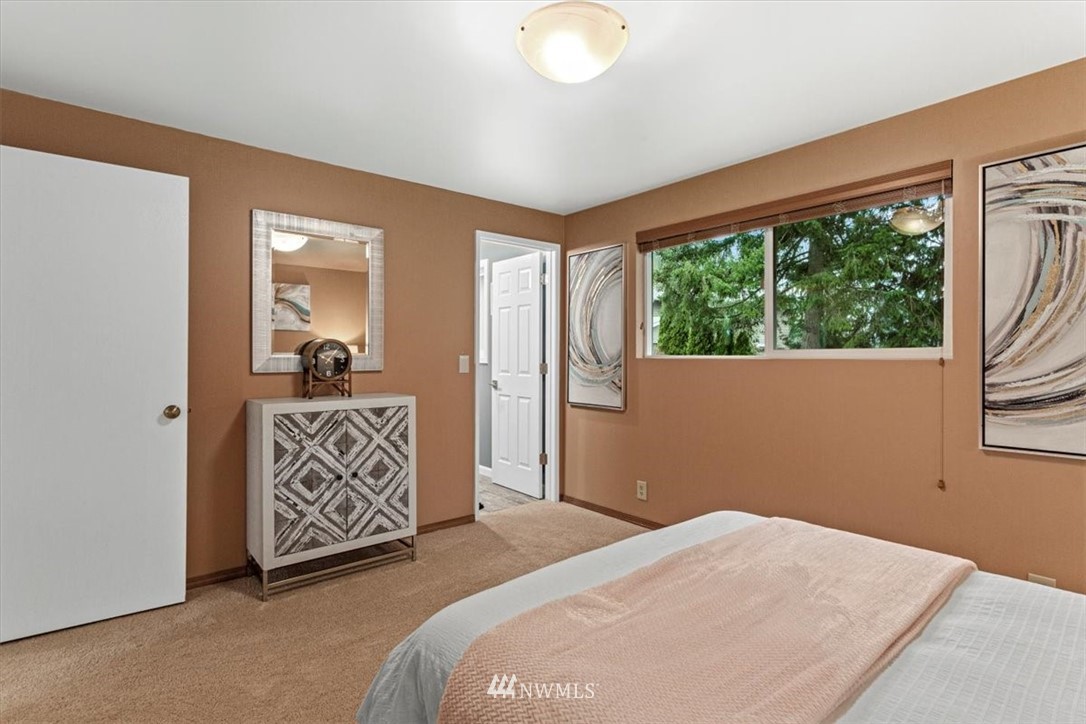 21918 7th Place West Bothell, WA 98021 - Photo 16 of 25 a bed room with a bed and a painting on the wall