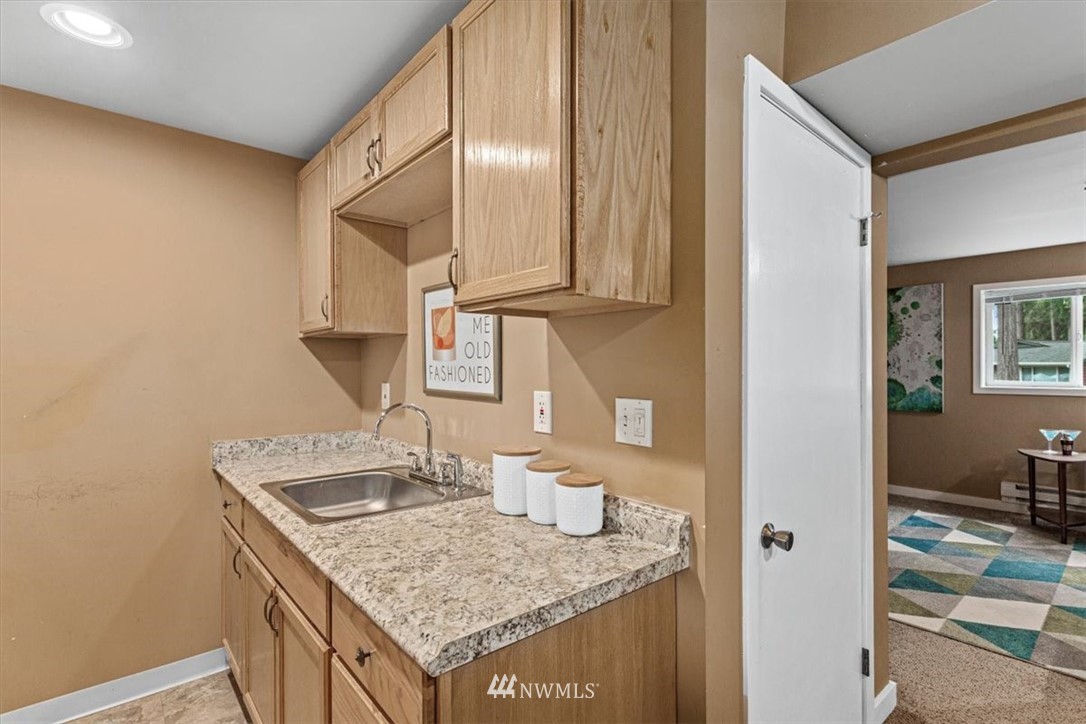 21918 7th Place West Bothell, WA 98021 - Photo 21 of 25 a kitchen with granite countertop a sink and cabinets