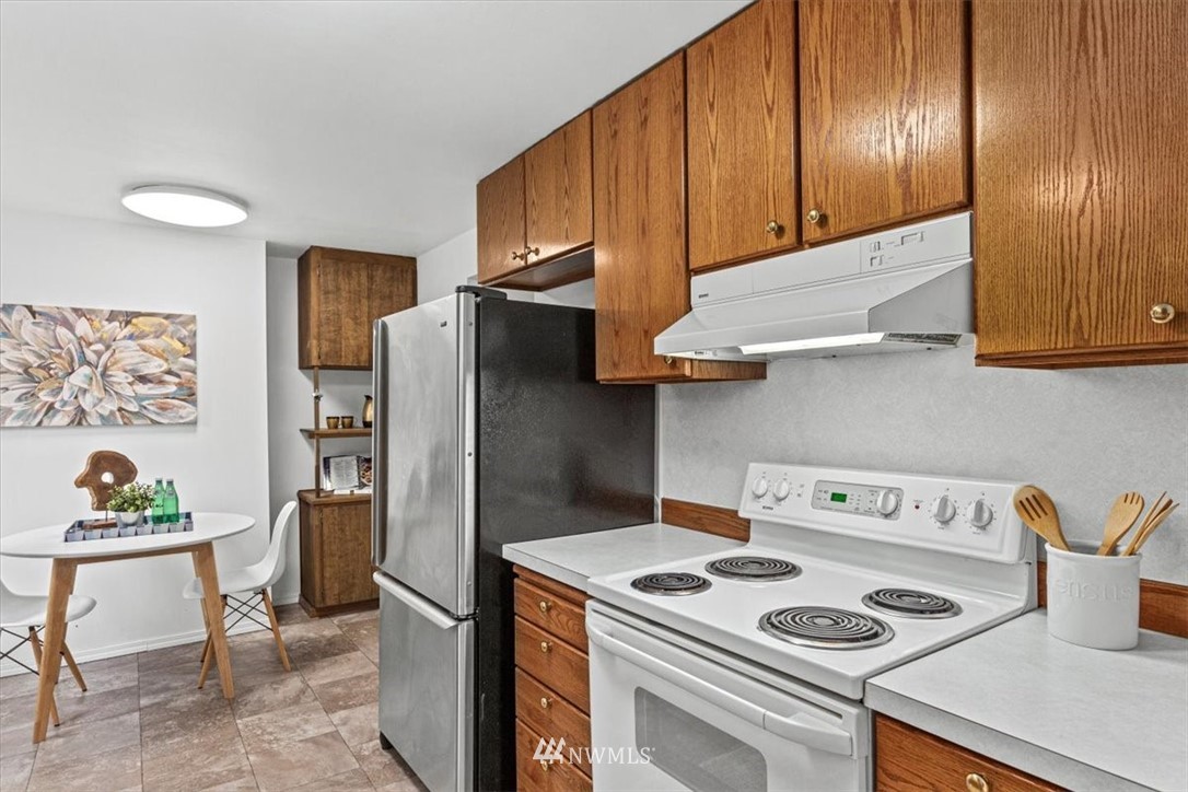 21918 7th Place West Bothell, WA 98021 - Photo 8 of 25 a kitchen with a refrigerator and a stove top oven