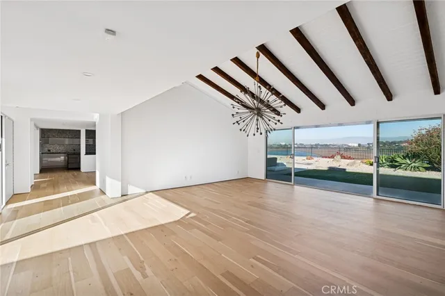 a view of a room with wooden floor