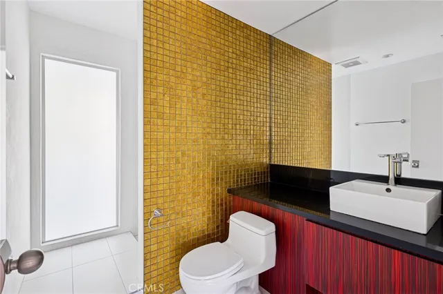 a bathroom with a sink a toilet and shower curtain