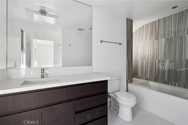 a bathroom with a sink toilet vanity and shower