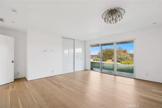a view of room with window and wooden floor