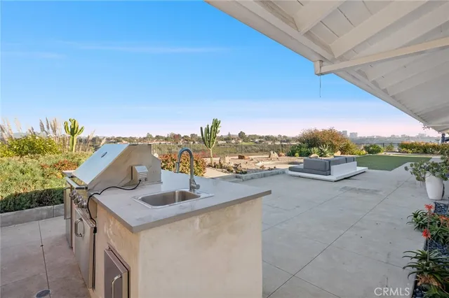 a view of a terrace with lawn chairs