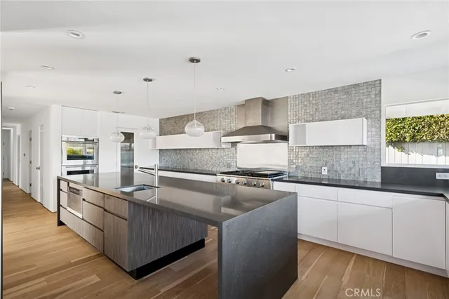 a kitchen with stainless steel appliances granite countertop a stove a sink and a refrigerator