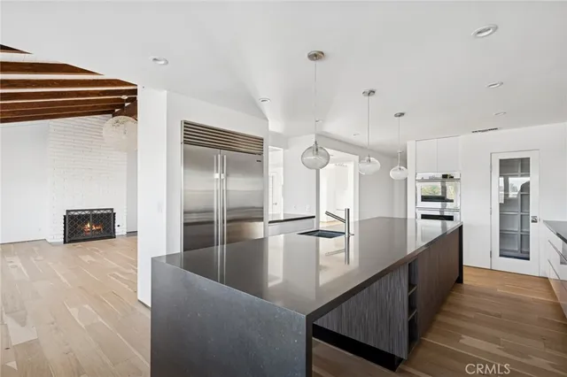 a kitchen with stainless steel appliances granite countertop a refrigerator and a sink