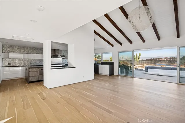 a view of a kitchen with furniture and wooden floor