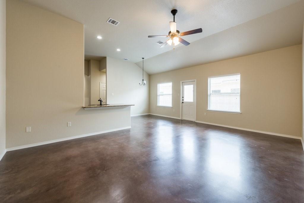 491 Jack Rabbit Lane, Unit A Buda, TX 78610 - Photo 8 of 22 An open concept living area boasts a kitchen pass-through and durable concrete flooring.