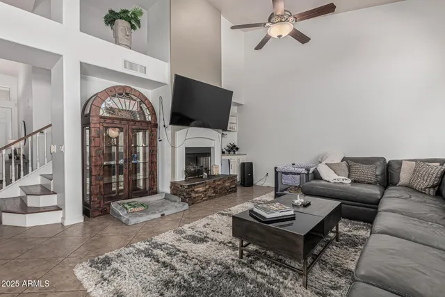 a living room with furniture a rug and a flat screen tv