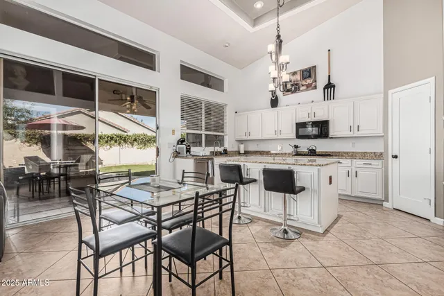 a kitchen with stainless steel appliances kitchen island granite countertop a sink and cabinets