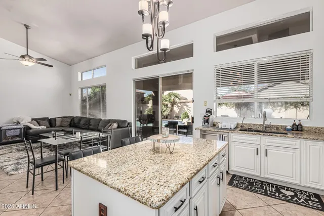 a kitchen with center island table and chairs