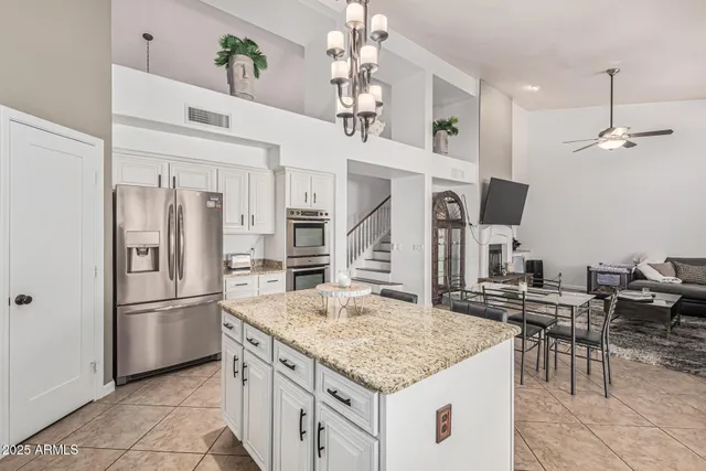 a kitchen with center island table and chairs