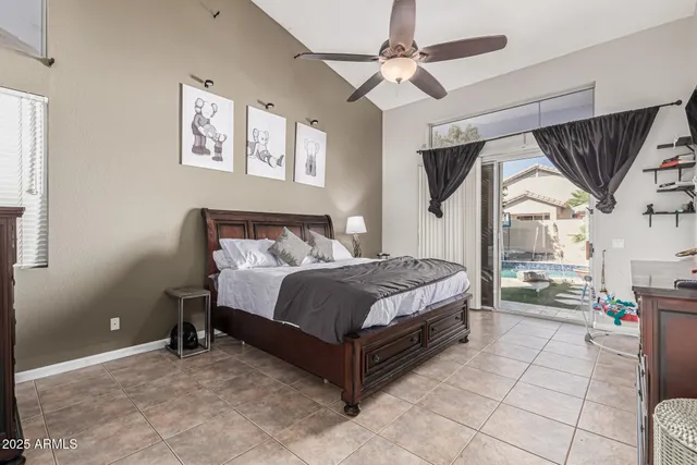 a bedroom with a large bed a flat tv screen and furniture