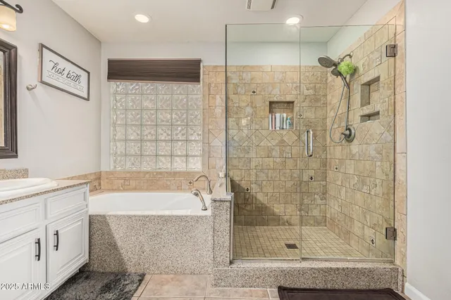 a bathroom with a bathtub shower sink and mirror