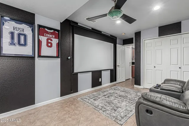 a bedroom with bed and ceiling fan