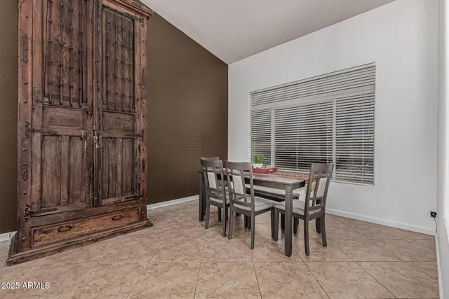 a view of a dining room with furniture and window
