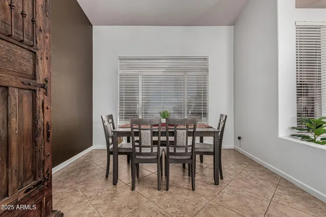 a view of a dining room with furniture and window