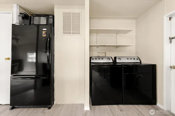 a kitchen with a refrigerator and cabinets